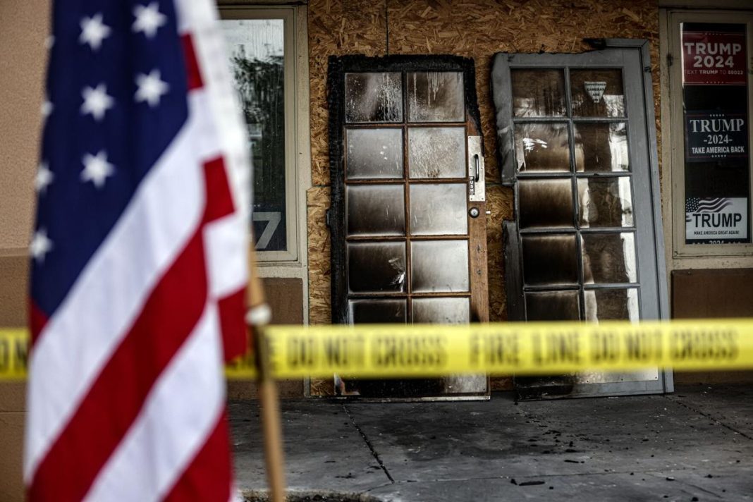 The scorched entryway doors of the Republican Party of New Mexico’s Albuquerque headquarters in March 2025.