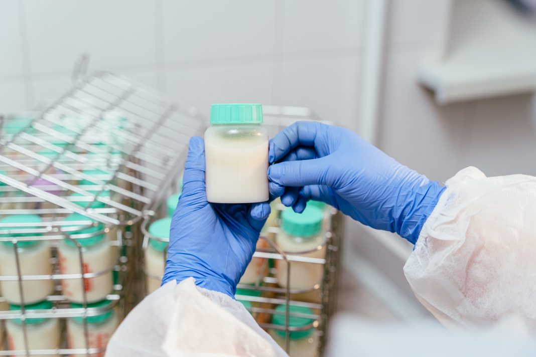 Healthcare professional conducting newborn milk testing in a laboratory, checking for harmful bacteria to protect infants from listeria and ensure safe nutrition.