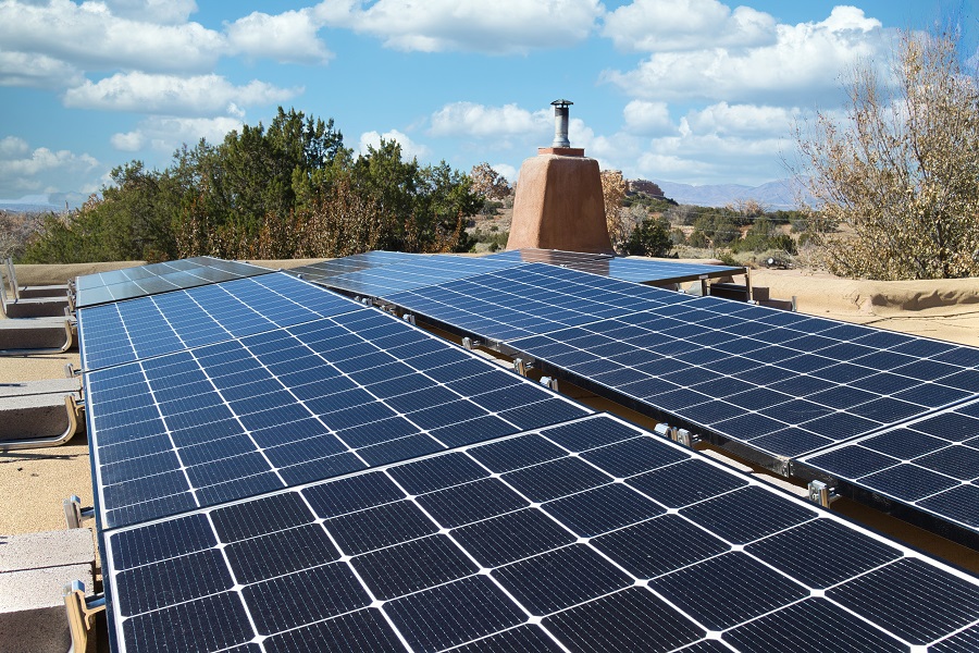 Solar panel installation on a flat New Mexico roof, in horizontal format