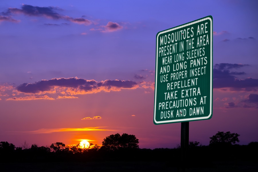 Mosquitoes warning sign against evening sky