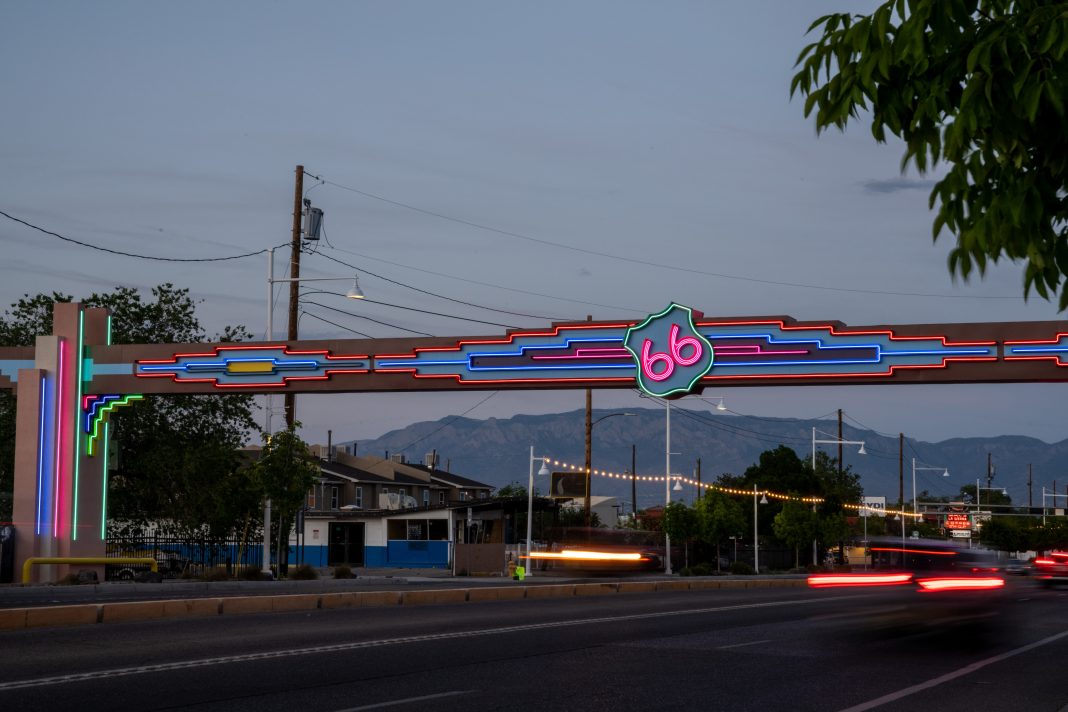 Visitors explore historic Route 66 in Albuquerque, featuring vintage neon signs, local businesses, and cultural landmarks.