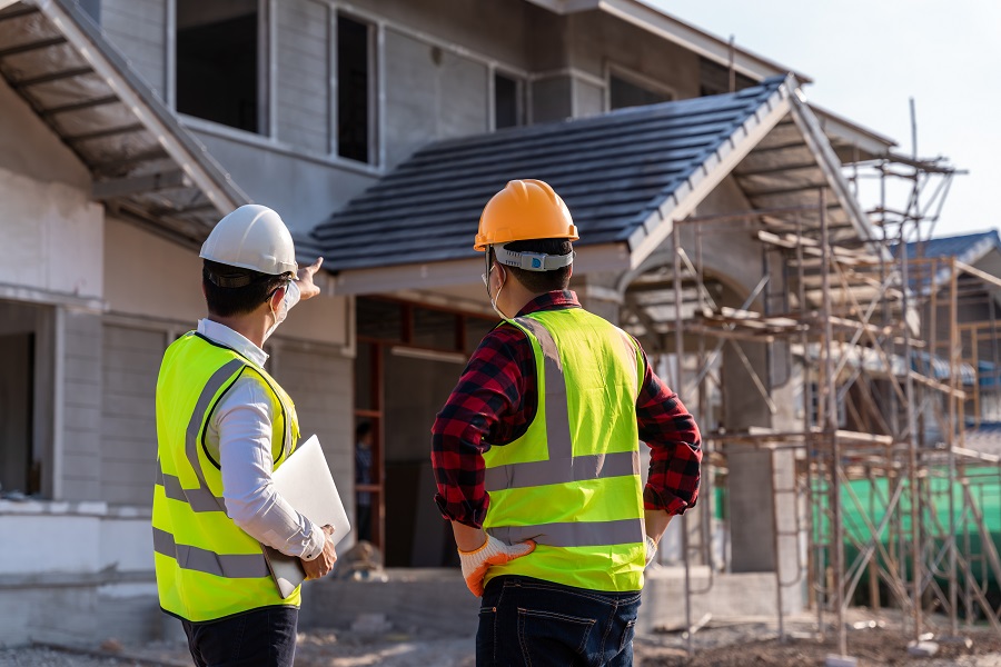 Engineer recommend house construction to supervisor supervisors at construction site. House builder concept.