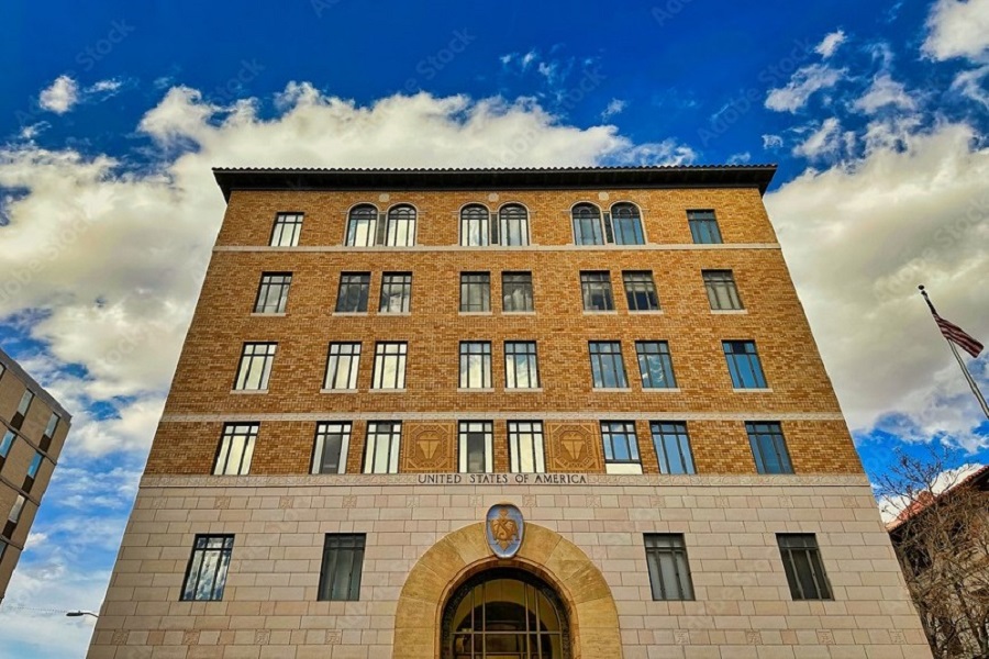 ALBUQUERQUE, NEW MEXICO, USA - March 8, 2023. Low angle view of federal courthouse against blue sky with white clouds.