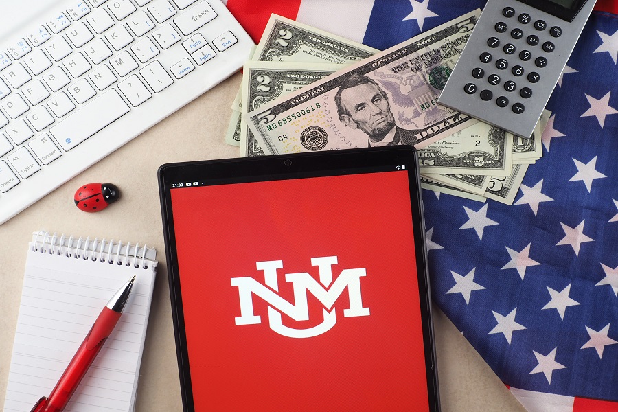 In this photo illustration, Washington State University, University of New Mexico logo seen displayed on a tablet.